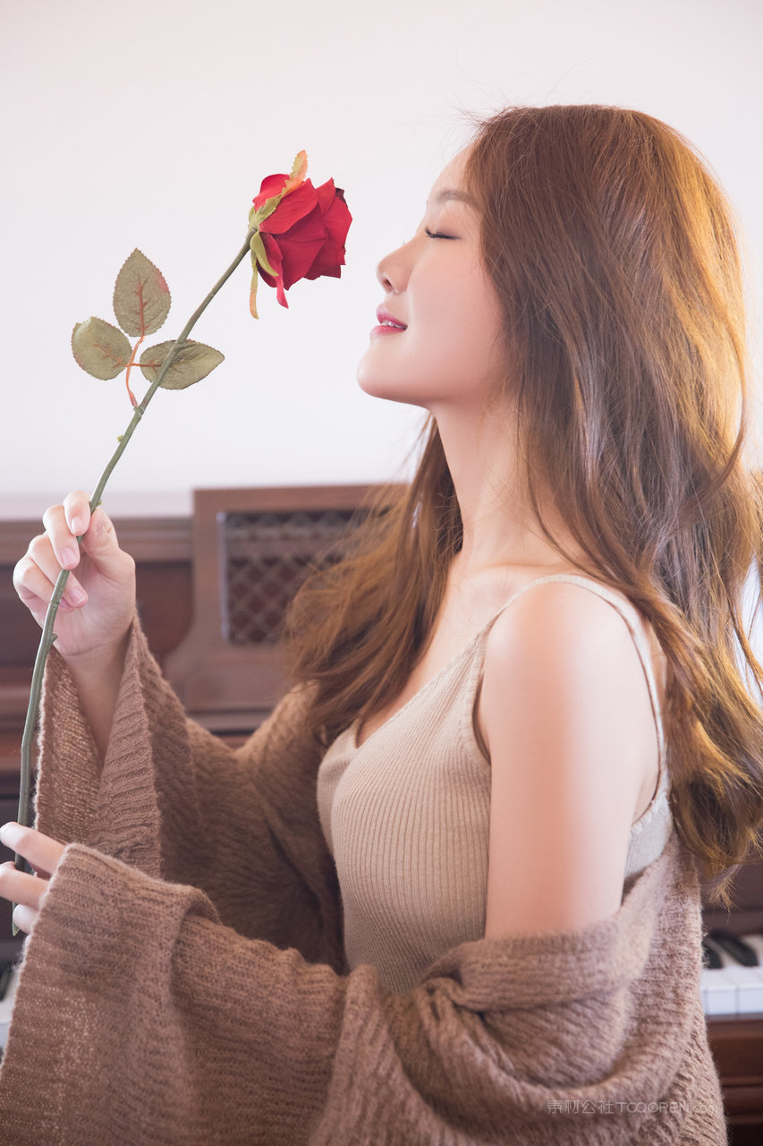 手拿玫瑰的漂亮小姐姐侧脸写真图片